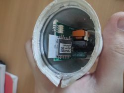 Inside the ExtraStar A60WIFI-2 Smart Bulb Disassembled ExtraStar A60WIFI-2 smart bulb with exposed PCB and wires attached for programming.