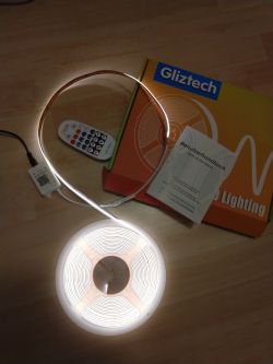 Cob Led Strip from Gliztech Cob Led Strip with color temperature of 3000K to 6500K against a Gliztech box with remote and user manual.