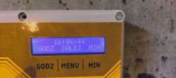 Timer programmer display showing the time and settings menu.