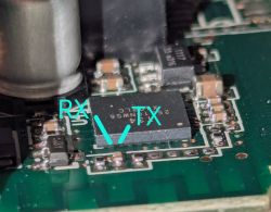 Close-up of a PCB with an IC and overlaid RX and TX labels pointing to pins