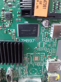 Close-up of a motherboard with visible integrated circuits and USB ports.