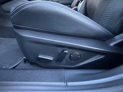 View of a car seat adjustment panel in black leather.