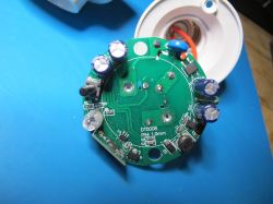 Circuit board with electronic components mounted in an E27 lamp holder.