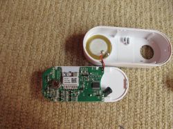 Inside the Tuya Alarm Device Disassembled battery-powered Tuya alarm device with exposed components.