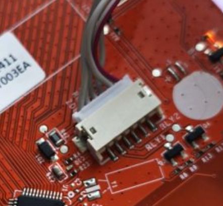 Close-up of connector on red PCB with GND and 3.3V markings