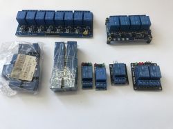 Set of relay modules of various sizes on a white background.