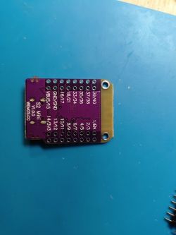 Printed circuit board with labels on a blue background.