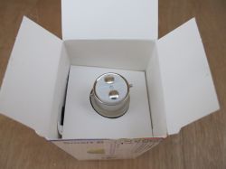 GU10 bulb in open packaging Open box with a GU10 bulb seen from above, showing metal connector pins.