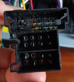 Close-up of a car electrical connector with visible pins.
