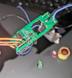 Printed circuit board with electronic components and soldered wires.