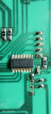 Close-up of green PCB with IC labeled AP2003 and various SMD components