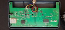PCB in a Yieryi Water Quality Tester Green PCB board with multicolored wires and electronic components in an open case.