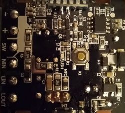 Close-up of a circuit board with visible integrated circuits, including markings TX, RX, and MCU.