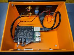 Interior view of orange enclosure with Raspberry Pi 4 and IQaudIO DAC Pro board
