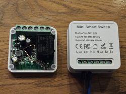 Mini Smart Switch with Open Case Open Mini Smart Switch showing internal electronics and cover with external markings.