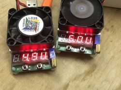 Load Testers LD25 and LD35 with Fans Two electronic load testers with fans on a wooden surface.