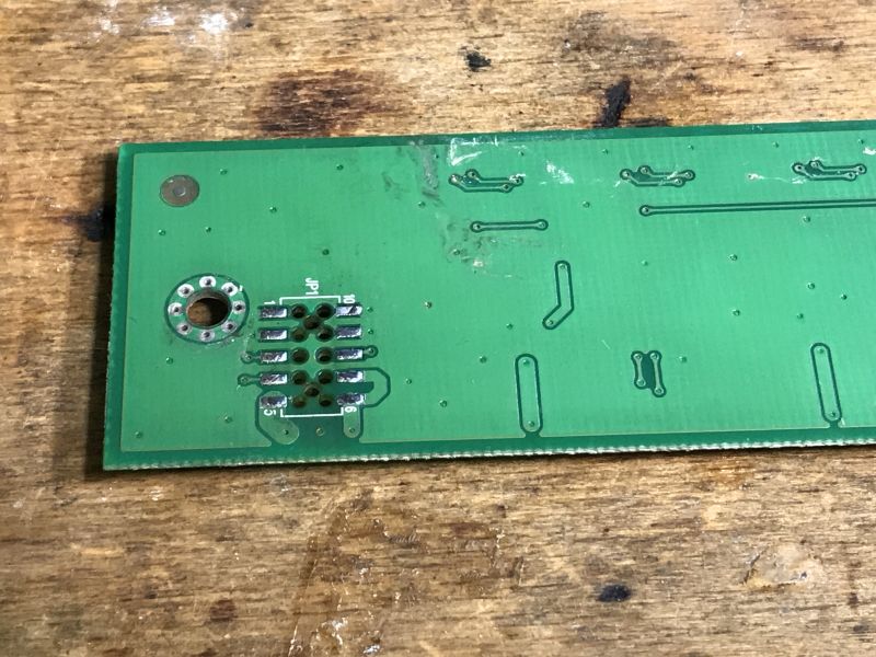 Circuit Board with Visible Pads and Traces Image of a circuit board from electronic waste, showing rows of pads and traces.