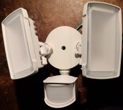 LED floodlight with two light panels and a motion sensor.