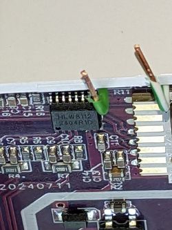 Close-up of a circuit board with a visible integrated circuit marked HLW8112.