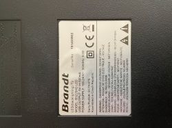 Nameplate of a Brandt TV with technical information and safety warnings.