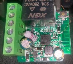 Close-up of a circuit board with various electronic components, including capacitors and a relay.