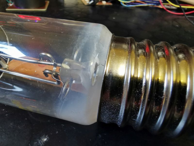 Close-up of a screw base and interior of a large vacuum tube bulb