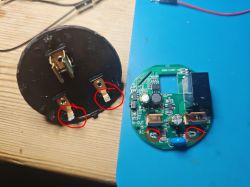 Interior of Tuya BSD29 Smart Plug View of the interior of a smart plug with a round PCB and metal connectors.