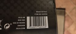 Barcode with product number and origin label on black packaging