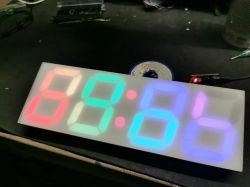 Colorful LED clock with 7-segment displays made from frosted acrylic.