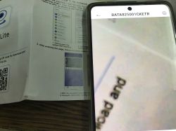 A phone displaying a magnified text, next to a user manual with a QR code.