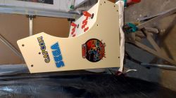 Building a Bartop Arcade Game Cabinet Wooden Bartop arcade game cabinet with Capcom, Sega, and Attack Mars stickers in progress.