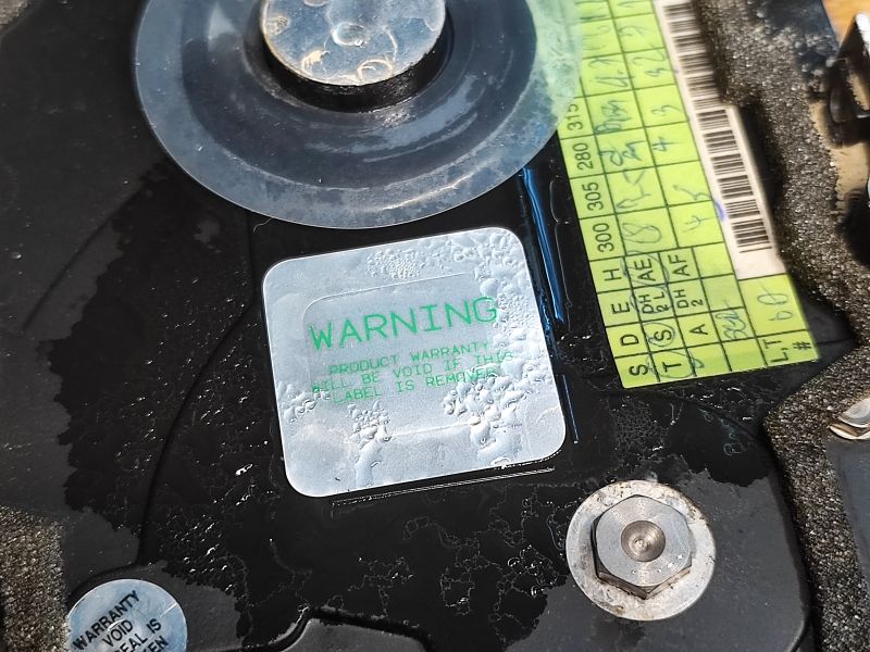 Warning Label on a Flooded Seagate Drive Close-up of a warning label on a flooded Seagate hard drive from 1994.