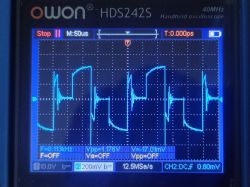 Signal Waveform on Oscilloscope Screen Oscilloscope screen displaying a waveform with a frequency of about 8.113 kHz.