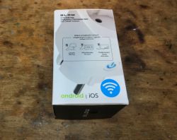 Blow WiFi Smart Socket Box Blow WiFi Smart Socket box on a wooden table.
