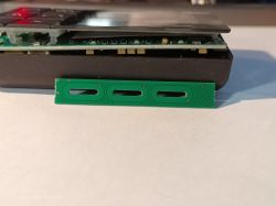 Close-up of green touch panel beside the casing of a disassembled electronic device