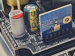 Close-up of a circuit board with electronic components and an AMS1117 module.