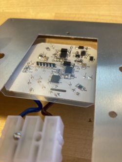 Printed Circuit Board of LSC SMART CONNECT Ceiling Light Close-up of a printed circuit board with electronic components mounted on a metal frame.