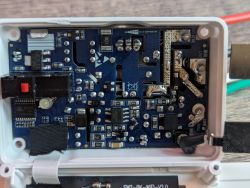Interior of a Shelly Plus wall dimmer showing integrated circuits and circuitry.