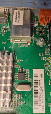 Close-up of a television interior showing components on a circuit board with labels.