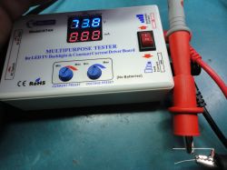 KT4H multipurpose tester with dual displays showing voltage and current.