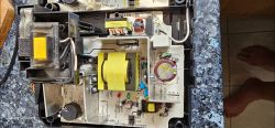 Inside of a Makita Charger Open Makita charger with visible circuit board and electronic components.