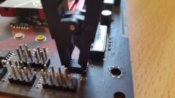 Circuit Board with Attached Clip Device with a clip connected to a chip on a circuit board.