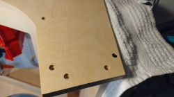 Building a Wooden Arcade Machine Enclosure Wooden enclosure with holes for screws.
