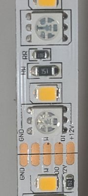 Close-Up of CasaLux LED Strip with GND and +12V Labels Close-up of an LED strip with pin labels and electronic components.