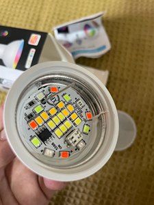 Interior of a GU10 LED bulb with visible diodes and components on a circuit board.