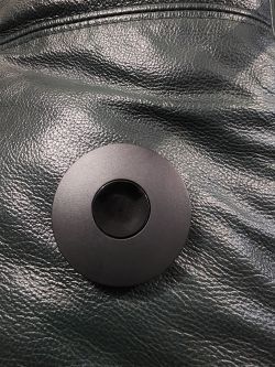 IR Emitter on Textured Surface Black circular IR emitter on a black textured surface.