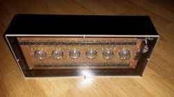 Nixie Clock in Plexiglass Case Nixie clock in a plexiglass case with exposed tubes and electronic components.
