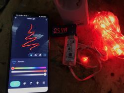 Smartphone and connected LEDs with a current meter showing 0.59A.