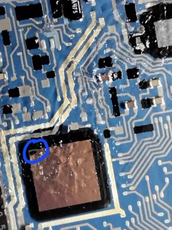 Damage on Opel Astra G Control Unit Circuit Board Close-up of a circuit board with a marked area indicating damage.