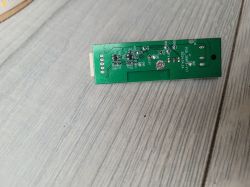 Electronic Device Circuit Board A circuit board lying on a wooden table.